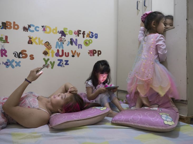 The Chen family cannot wait to check messages, play video games or look at the mirror following a day out in Chinatown (video still). New York City, 2017. © Chien-Chi Chang / Magnum Photos