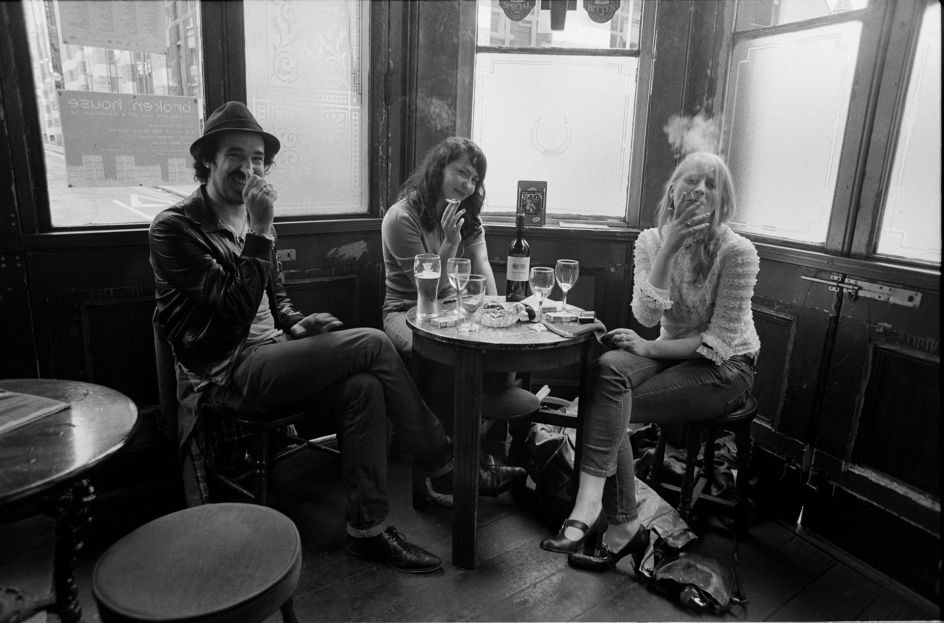 Friends enjoy a final smoke indoors on the final day of legal smoking in public places. The Griffin, Shoreditch - 2007