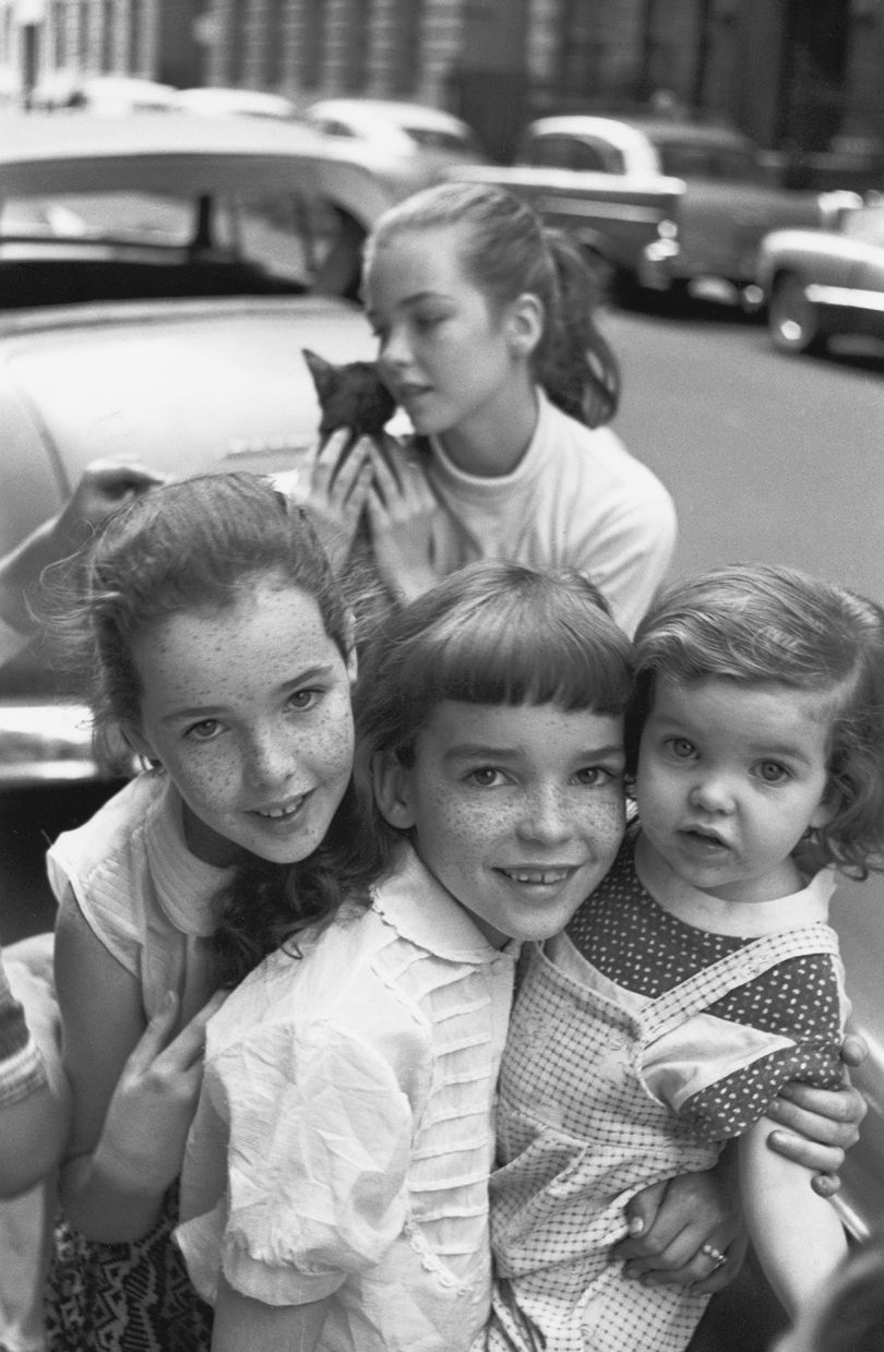 Four related girls, one holding a cat, 1957