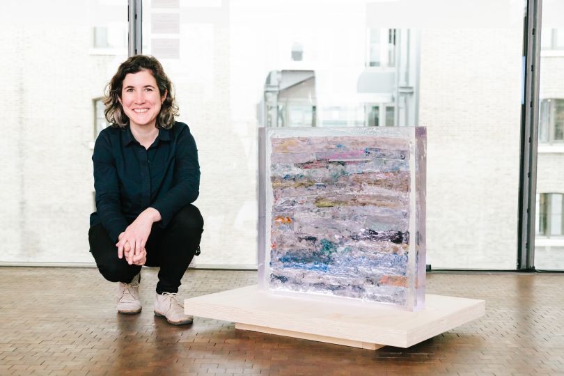 The artist pictured with the artwork ‘Strata’ - Low-density polyethylene cast in polyester resin, 65 x 65 x 10cm