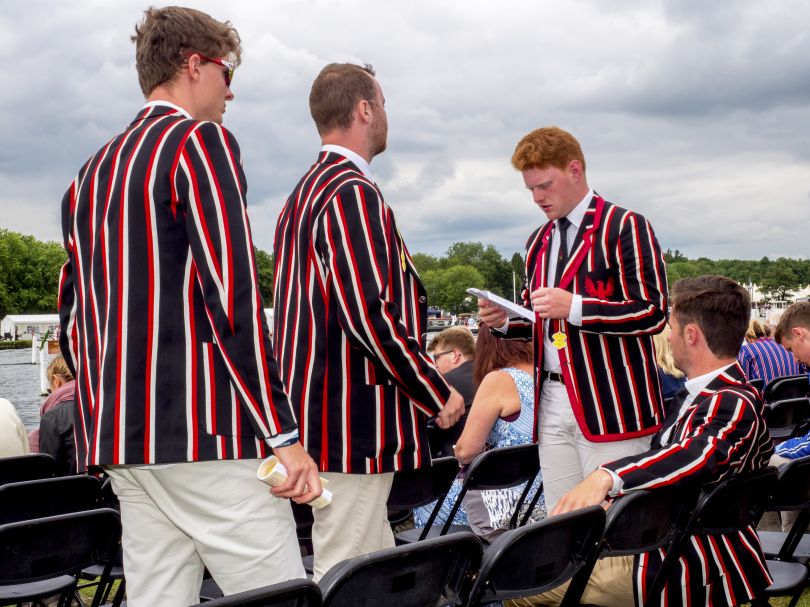 A crew wearing their club colours at the Henley Royal Regatta, a rowing event held annually on the River Thames. June 2017 © Peter Dench