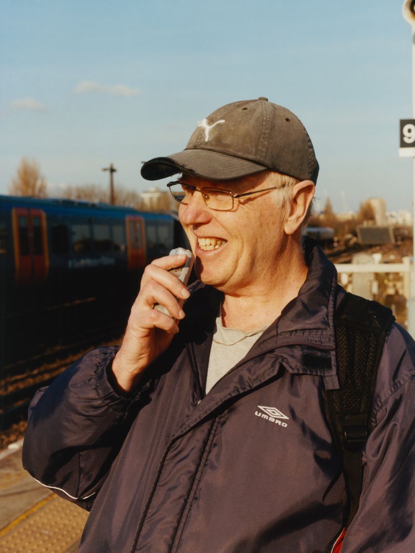 Recording train numbers with a dictaphone, Clapham Junction © Freddie Miller