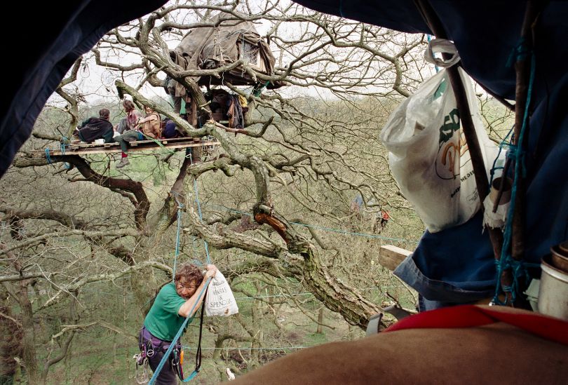 Stanworth Valley M65 Road protest 1995 – A protestor crosses the rope walkway to another treehouse.