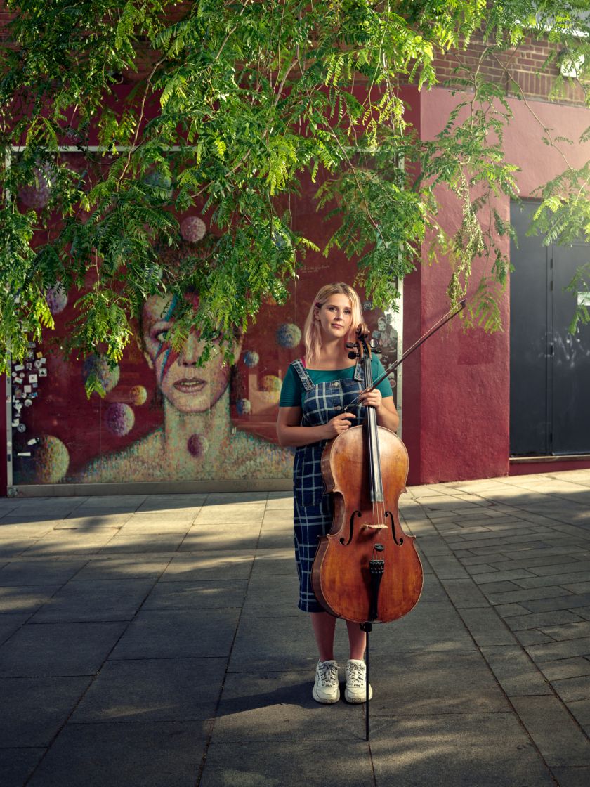 Ruby Moore - Cello, Tunstall Square in front of the Bowie mural © Michael Wharley