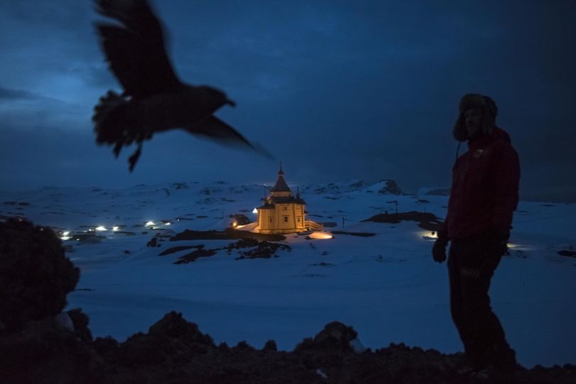Daily Life, first prize stories: A Chilean scientist walks above the Russian Orthodox Church of the Holy Trinity on the Bellingshausen Russian Antarctic base. Daniel Berehulak.