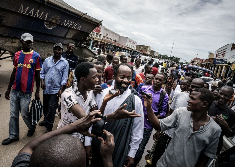 Jesus of Kitwe (born Mupeta Chishimba) proselytizing in a market place. Big crowds gather, recording his every word on their mobile phones. Zambia, 2015 | © Jonas Bendiksen/ Magnum Photos
