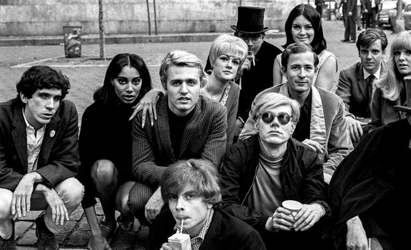 ‘Andy Warhol with Group at Bus Stop’, New York, 1966. © Nat Finkelstein Estate