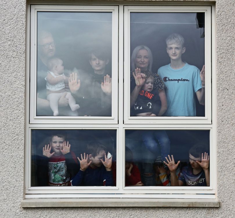 Grandparents and grandchildren visiting in isolation © Chris Page; Alexis and David Brett with nine of their sons and baby daughter, isolating in their home in Dingwall © Peter Jolly