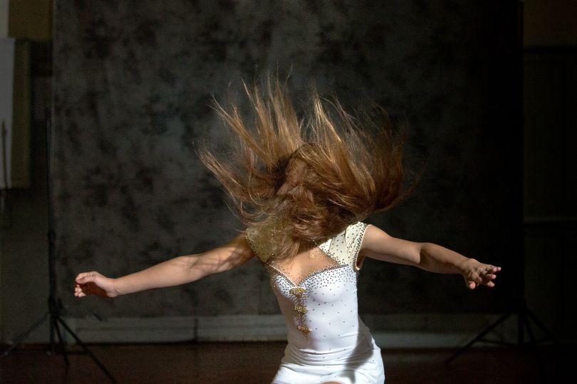 Molly executes a jump, her hair wild and free.
