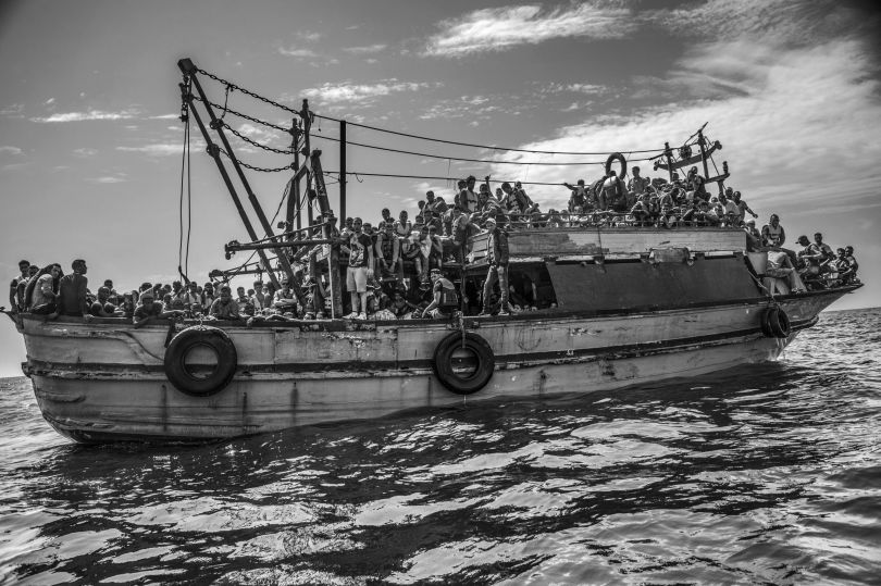 Contemporary Issues, second prize stories: A wooden fishing vessel sails from Libya to Italy carrying more than 500 migrants. Francesco Zizola.