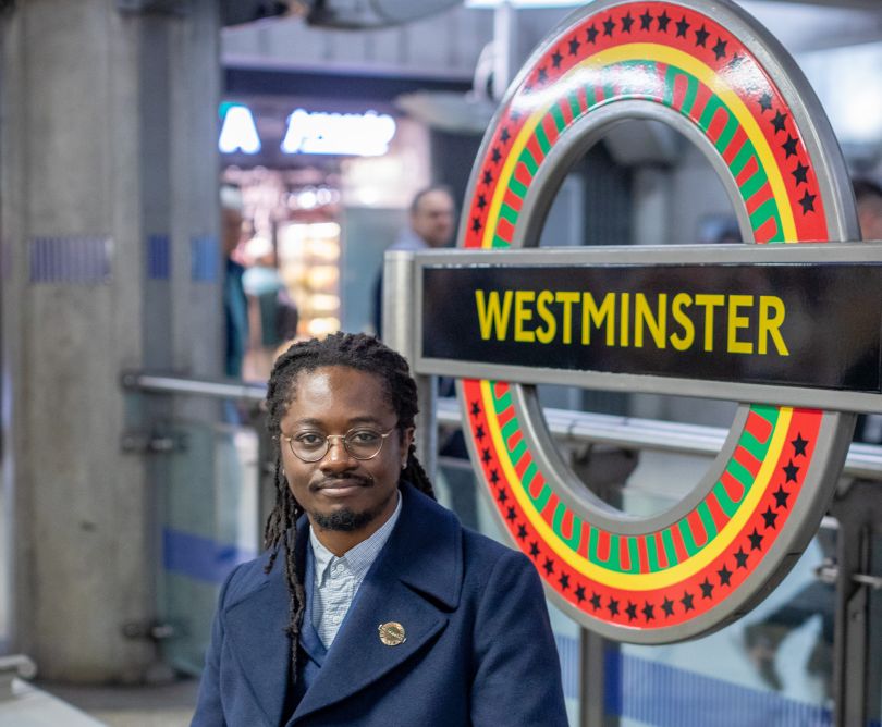 Larry Achiampong at Westminster Tube station recreating the iconic London Underground logo in Pan-African colours.