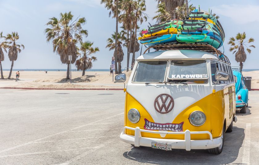 Surf boards stacked on a yellow van roof, sunny spring day. Venice beach, California USA. Image licensed via Adobe Stock, by Rawf8.