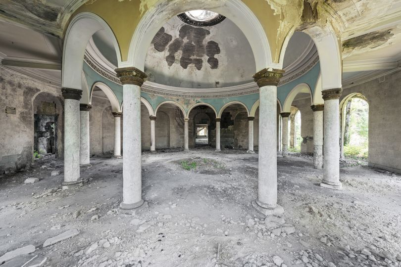Left in dismay, the view inside one of the many dining halls where the Soviet elite used to gather, featuring ornate arches and beautiful colors. Tskaltubo, Georgia. © Reginald Van de Velde