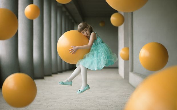 Girl in weightlessness holding a ball, among many others. The child represents gentleness and fragility. Associated with the ball, expressing the lightness, it is the word innocence that is symbolized. For this image, time would be synonymous with gravity. In Grenoble South-East of France, April 9, 2016 | © Alex Andriesi, Romania, Shortlist, Open, Enhanced, 2017 Sony World Photography Awards