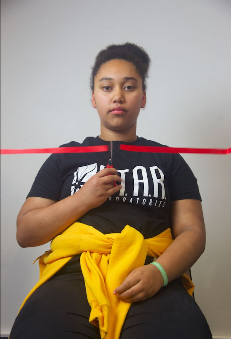 Tia Hume-Jennings Liverpool, 2018. “Tia spoke about how heart-breaking it was to experience racism. Together we decided to try to represent this by capturing her cutting the ribbon above her heart.” © UK Parliament