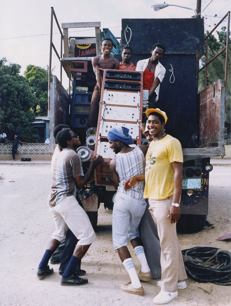 Loading King Jammy's sound system onto the truck, with Boxer on the ground on left in black Wallabees, unknown crew member next to him in Hoverveldt Gliders. Photgraph © Beth Lesser