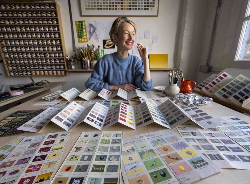 Rachel Spelling in front of her colour chart creations.