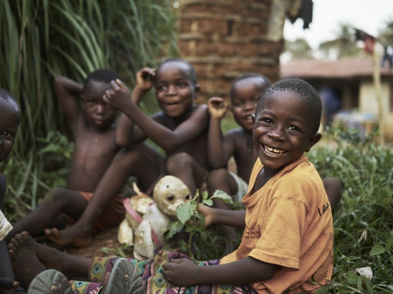 Joe Smart, 6, known as 'Strong Joe', plays with his friends, outside his home in the village of Tombohuaun, Kailahun District, Sierra Leone, May 2017. WaterAid/ Joey Lawrence