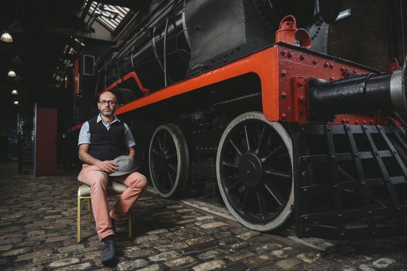 Artist Nikhil Chopra in front of Steam Locomotive 3157 at the Museum of Science and Industry, Manchester, 2017. Image courtesy of Museum of Science and Industry.