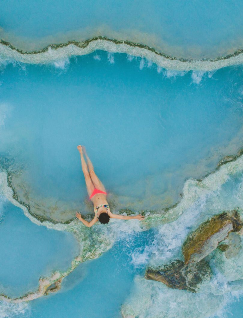 ID: [198230318](https://stock.adobe.com/uk/images/high-angle-view-of-teenage-girl-wearing-bikini-while-relaxing-in-hot-spring/198230318?prev_url=detail)