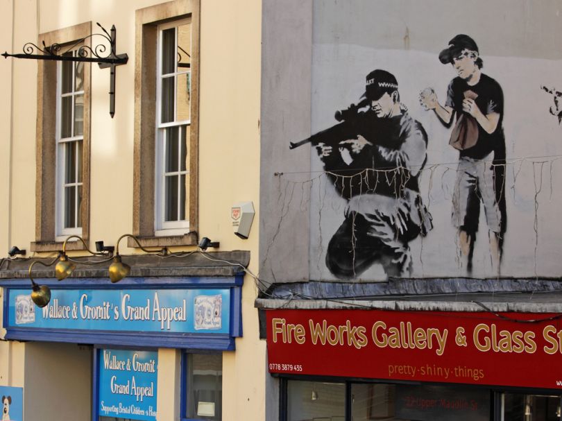 Police sniper by Banksy in Upper Maudlin Street in Bristol. Image Credit: pjhpix / Shutterstock.com
